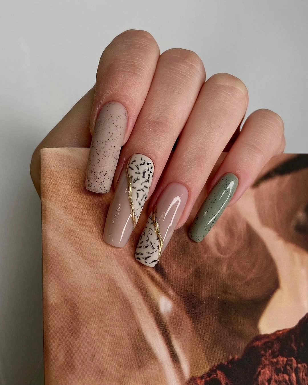 Long coffin nails in terracotta green pink and speckled cream