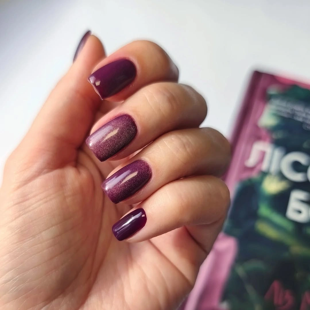 Medium rounded plum nails with glossy and subtle shimmer finishes