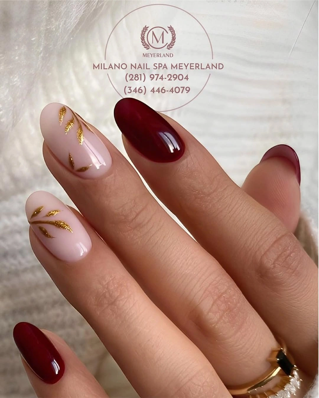 Burgundy almond nails with sheer pink gold leaf accents