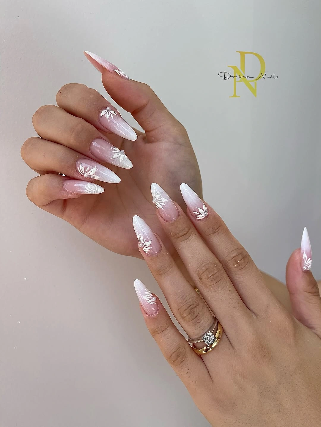 Pink to white ombre pointed nails with white leaves