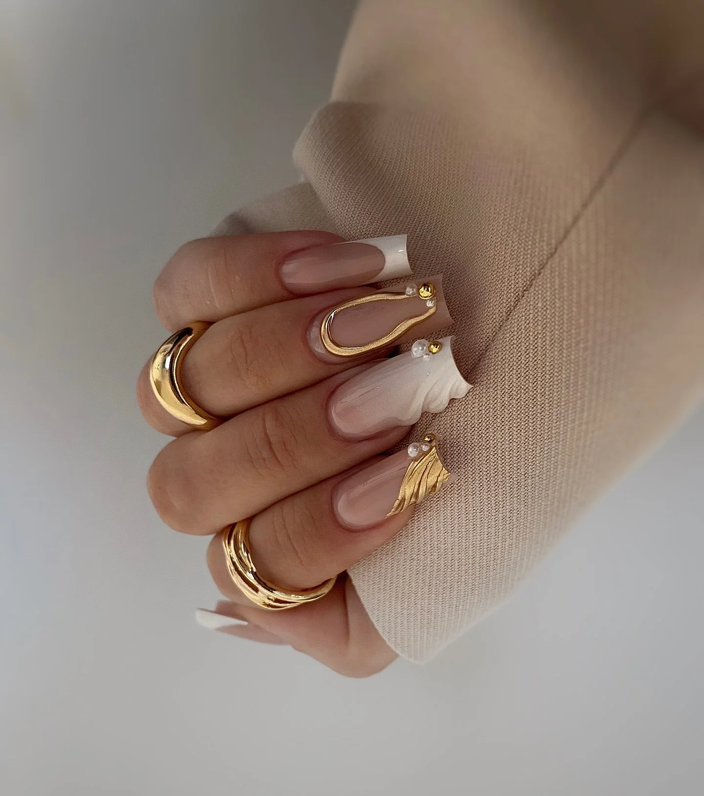 Long square nude French nails with pearl like gold details