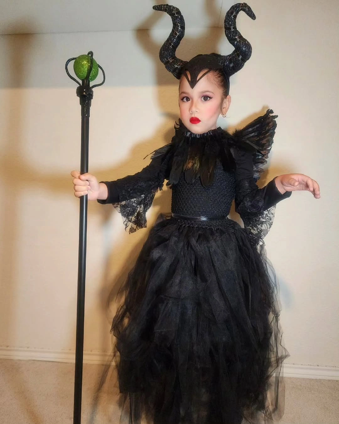 Maleficent child costume with curved black horns, dark wings, tulle skirt, and staff
