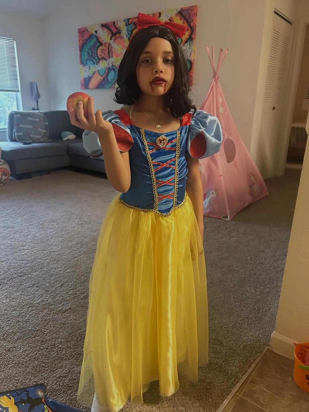 Zombie Snow White Halloween costume with blue bodice, yellow skirt, and apple