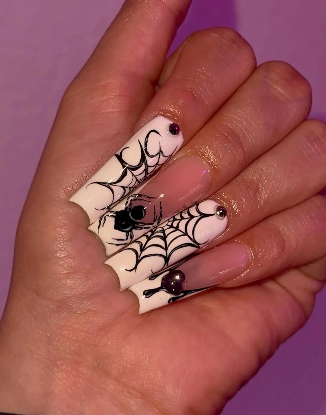 Long coffin nails with large webs and central black spiders