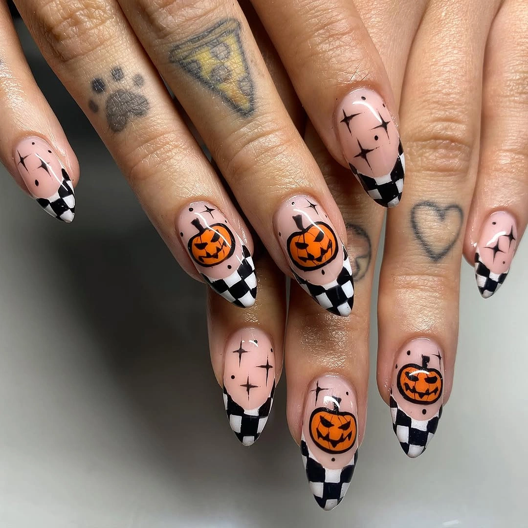 Long almond nails with checkerboard tips and tiny pumpkins
