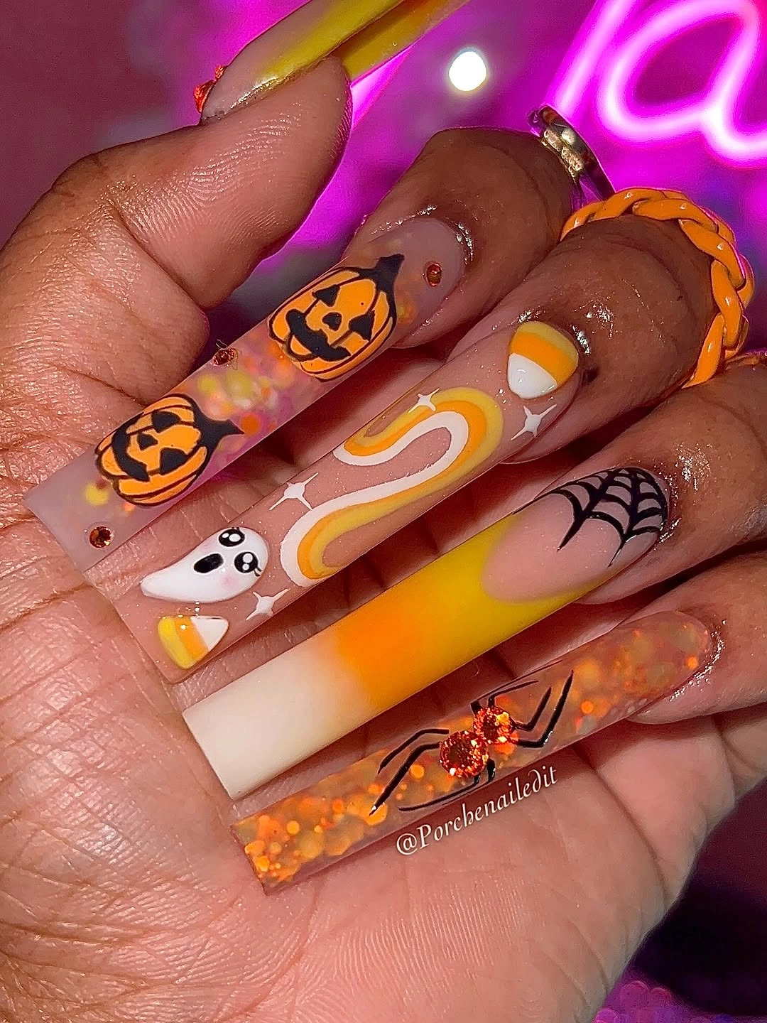 Long square nails with pumpkins, ghost, rainbow bands, and webs