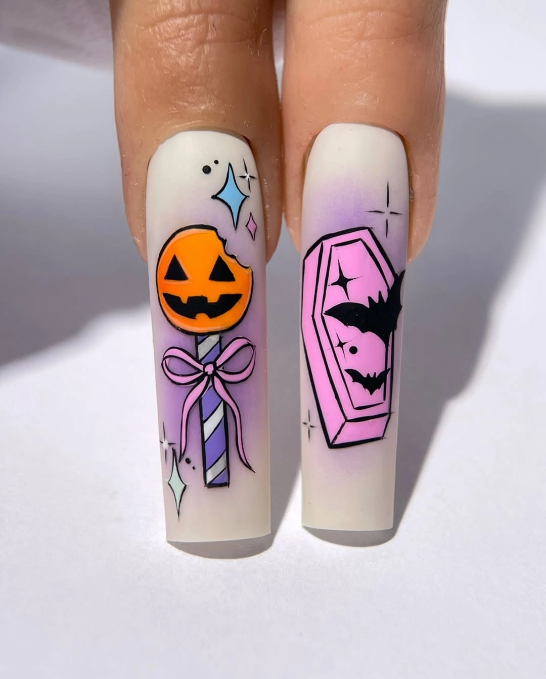 White and lilac sample tips with pumpkin, coffin, bats, and bow art