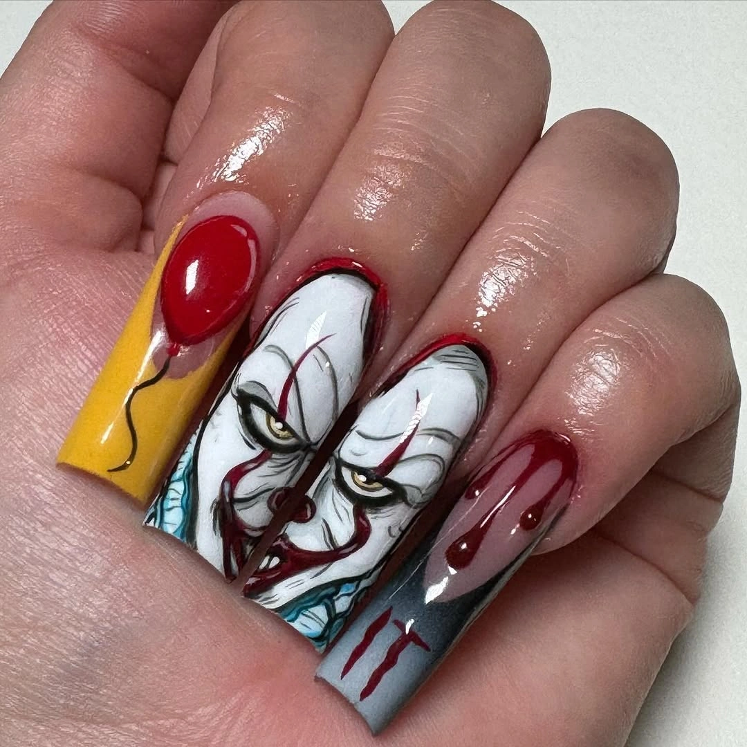 Long square nails with a clown-like face and red graphic details