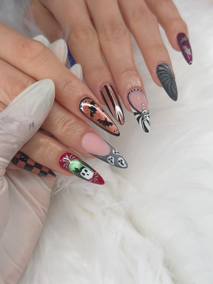 Long stiletto nails with checkerboard, stripes, and graphic faces
