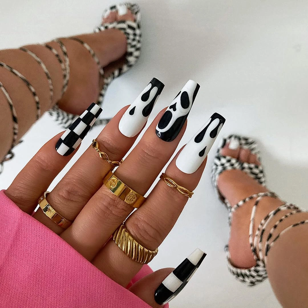 Long square nails with black white drips and a ghost accent