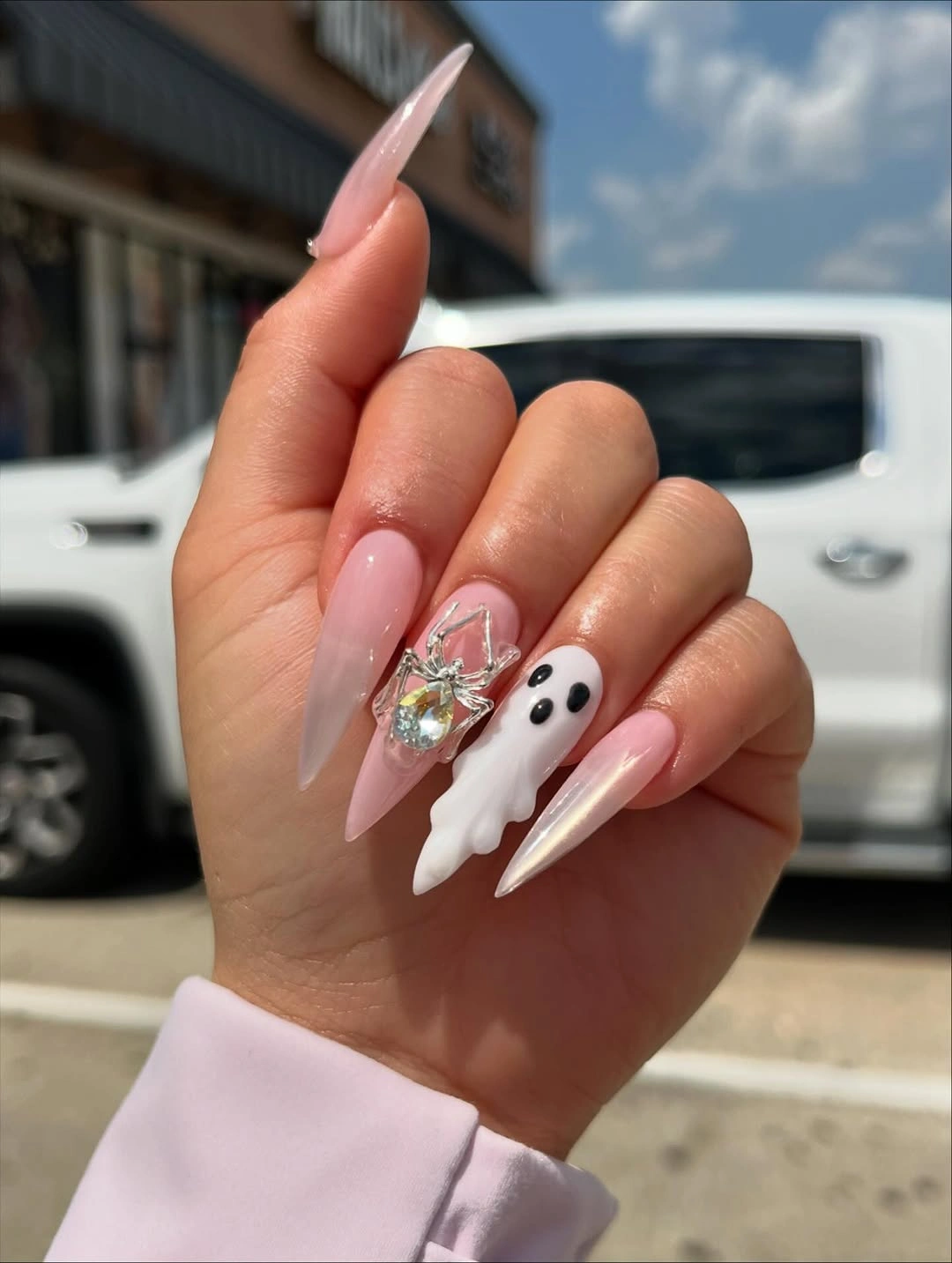 Sheer pink stiletto nails with white ghost and silver sparkle