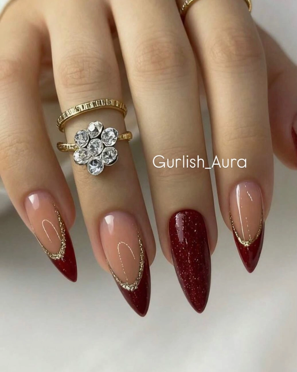 long nude coffin nails with burgundy tips fine gold borders and red glitter accent