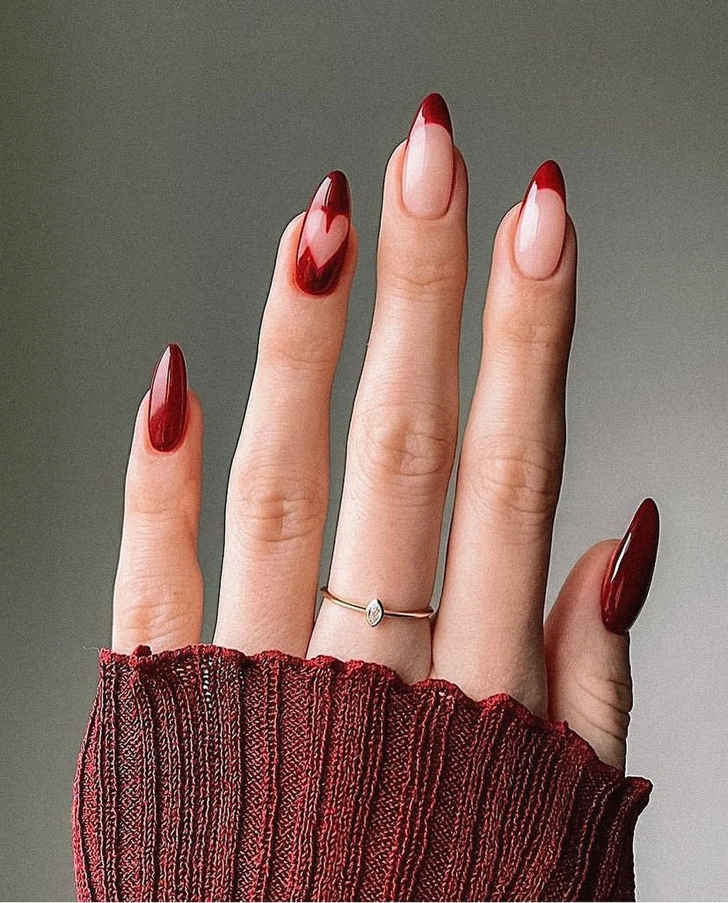 long nude almond nails with sculpted red burgundy diagonal French tips