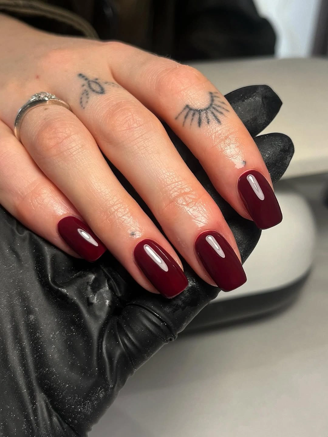 medium coffin nails in a uniform deep burgundy glossy color