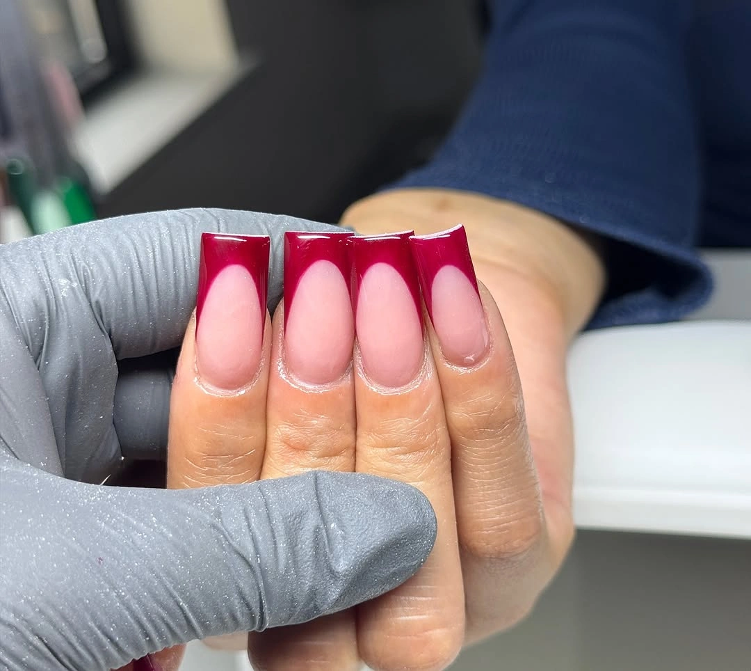 long pale pink square nails with layered maroon and bright pink tip blocks
