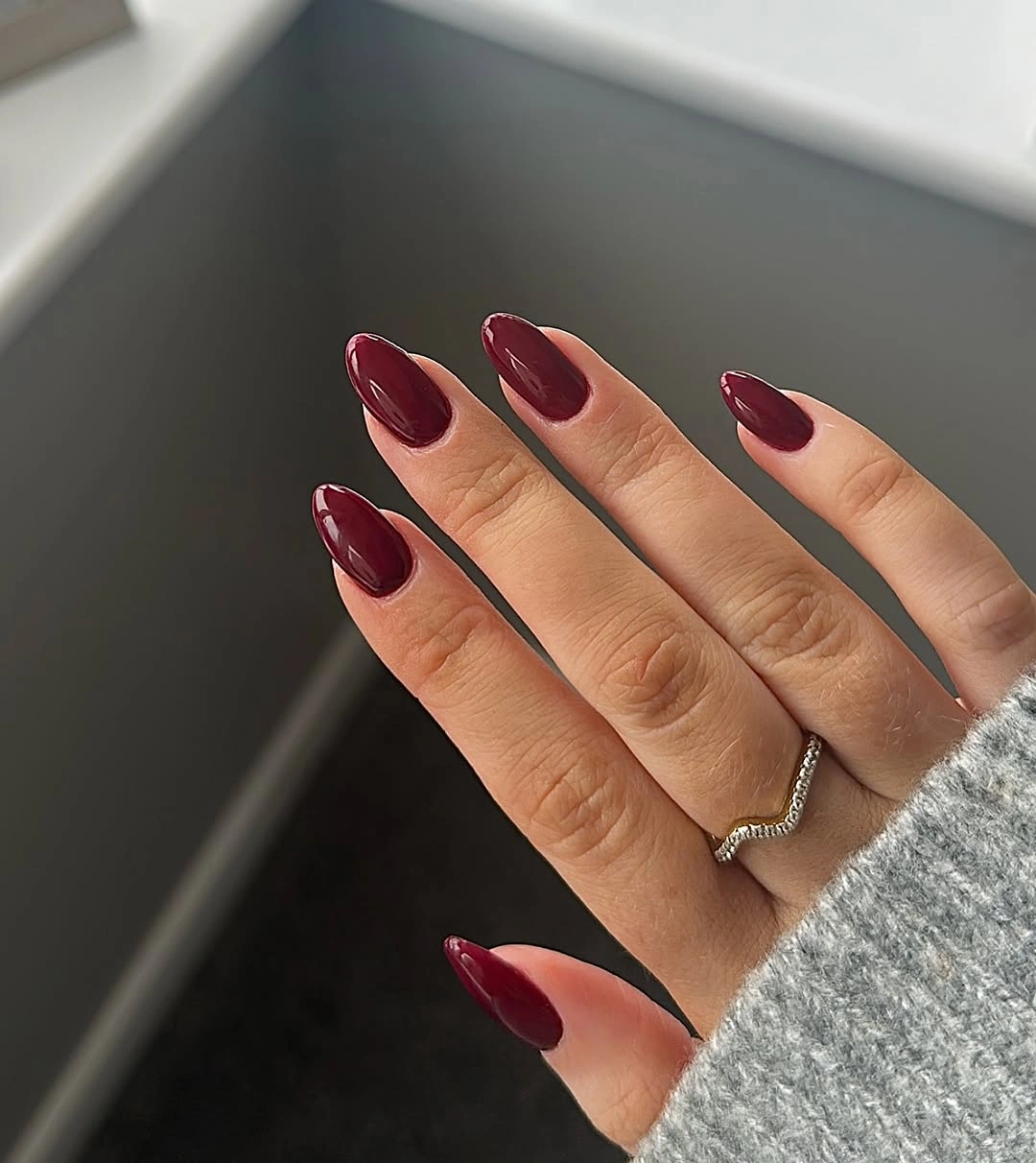 medium almond nails in a smooth glossy rich maroon shade