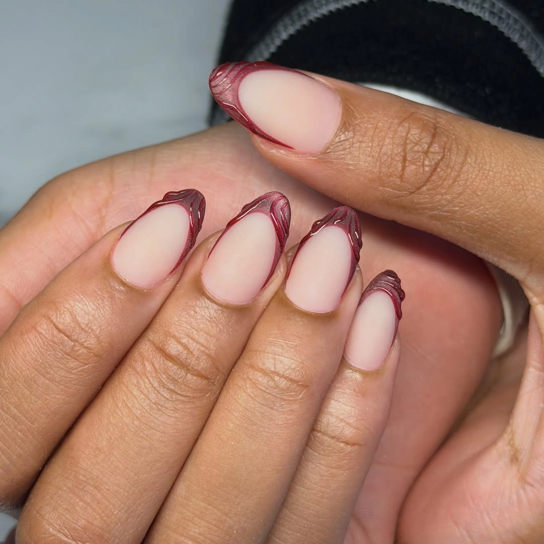 sheer pink almond nails with slim burgundy contour French tips