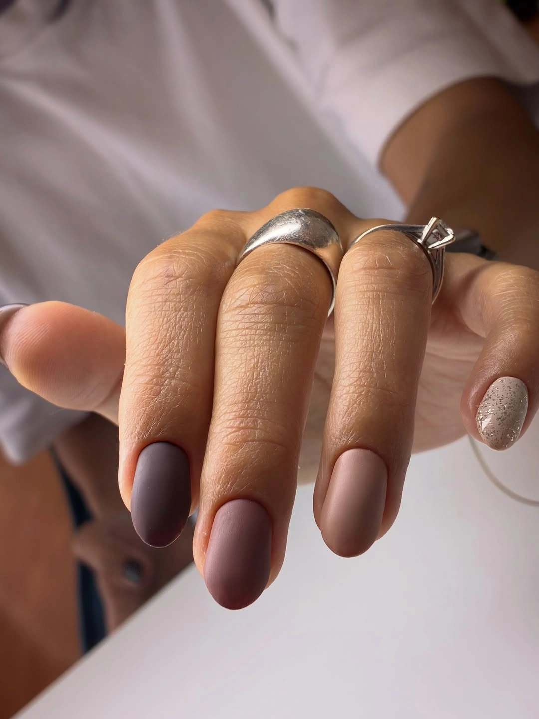 medium matte almond nails alternating taupe and cocoa brown solid colors