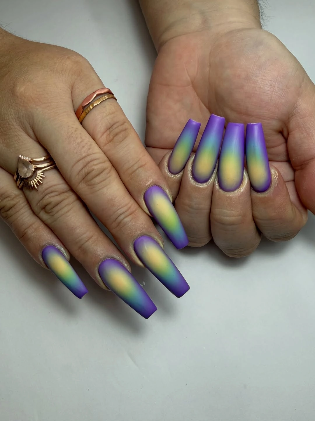 long purple coffin nails with a yellow green center glow gradient