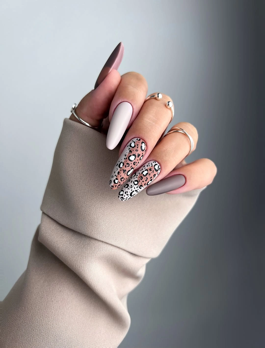 medium pale almond nails with dusty mauve solids and soft leopard-print accents