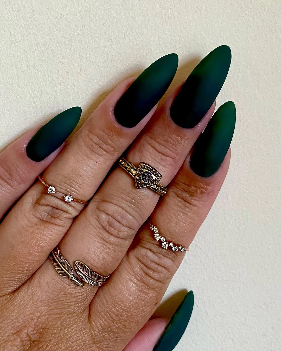 long matte pointed nails fading from black into deep forest green