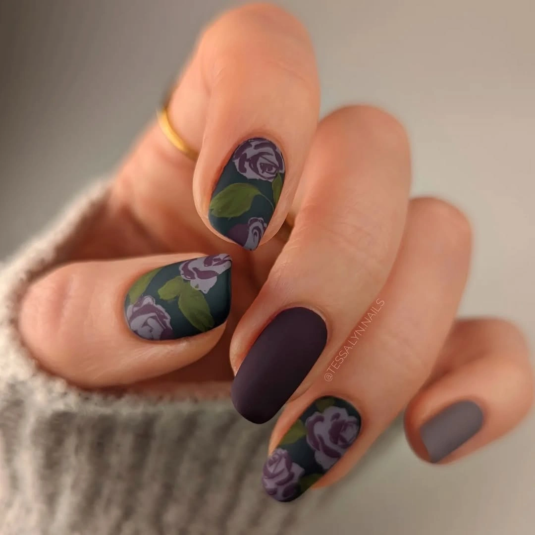 short matte mauve nails with muted green and purple floral accents