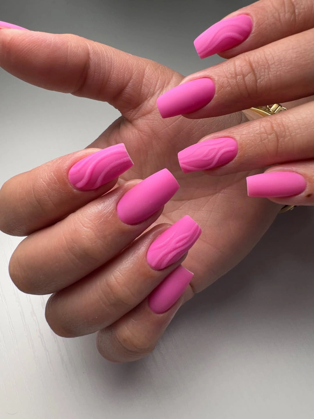 matte hot pink square nails with darker pink flowing wave patterns