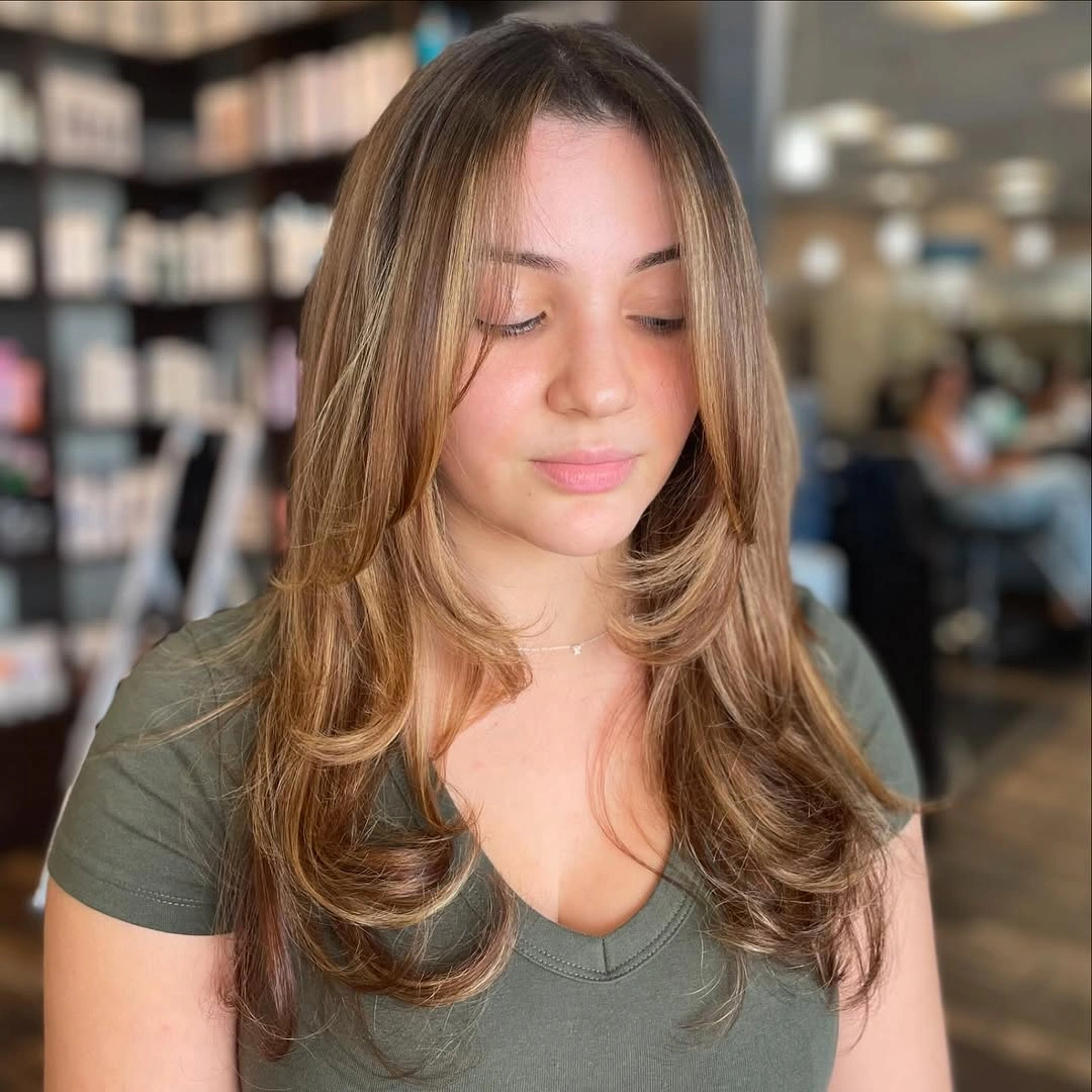 Long light-brown middle-parted layers with a smooth curved blowout