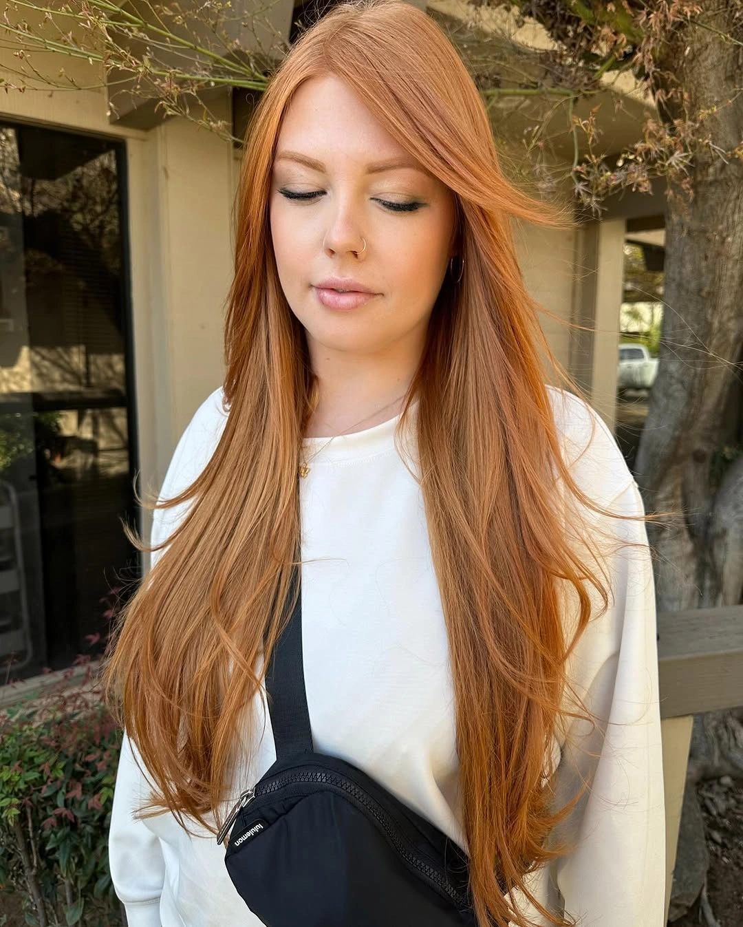 Very long copper center-parted hair with a smooth straight fall