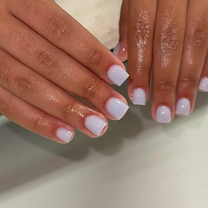 Short lavender pink square nails with a pale blue-white diffused tip transition
