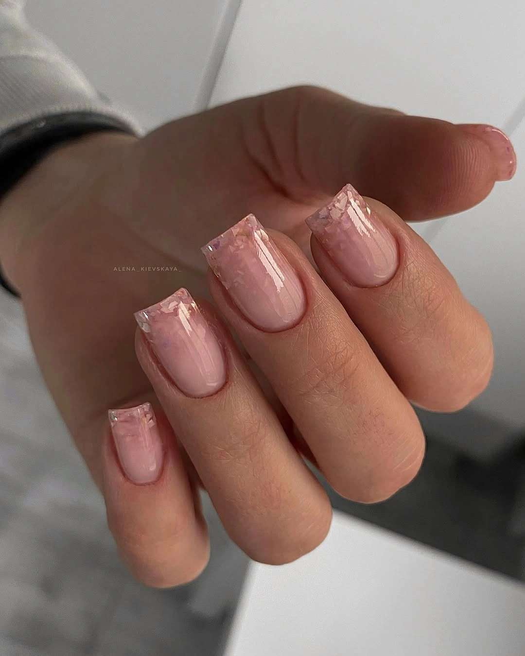 Medium blush square nails with clear-looking ends and fine shimmering detail