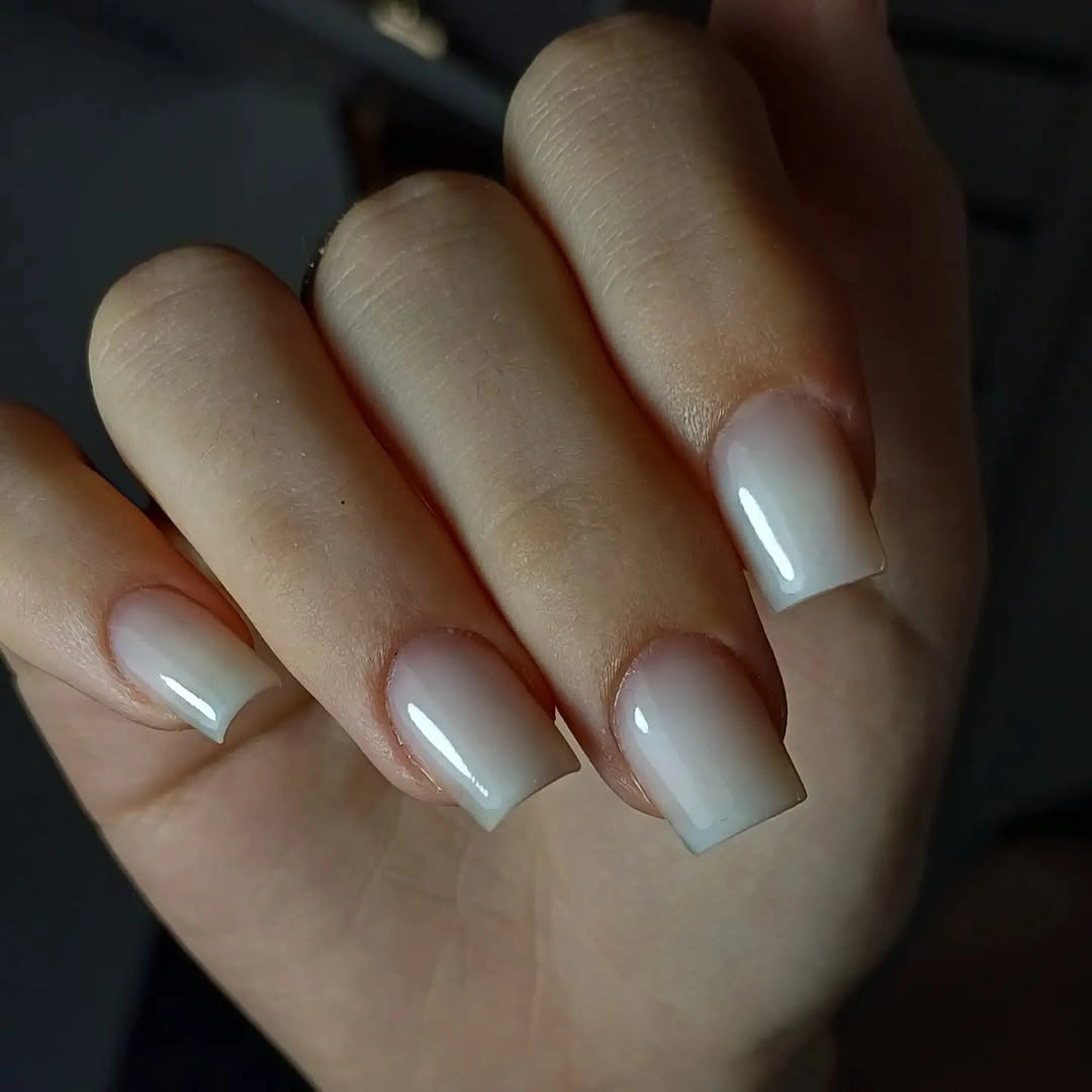 Medium square nails with milky nude base and a soft pale white-blue edge