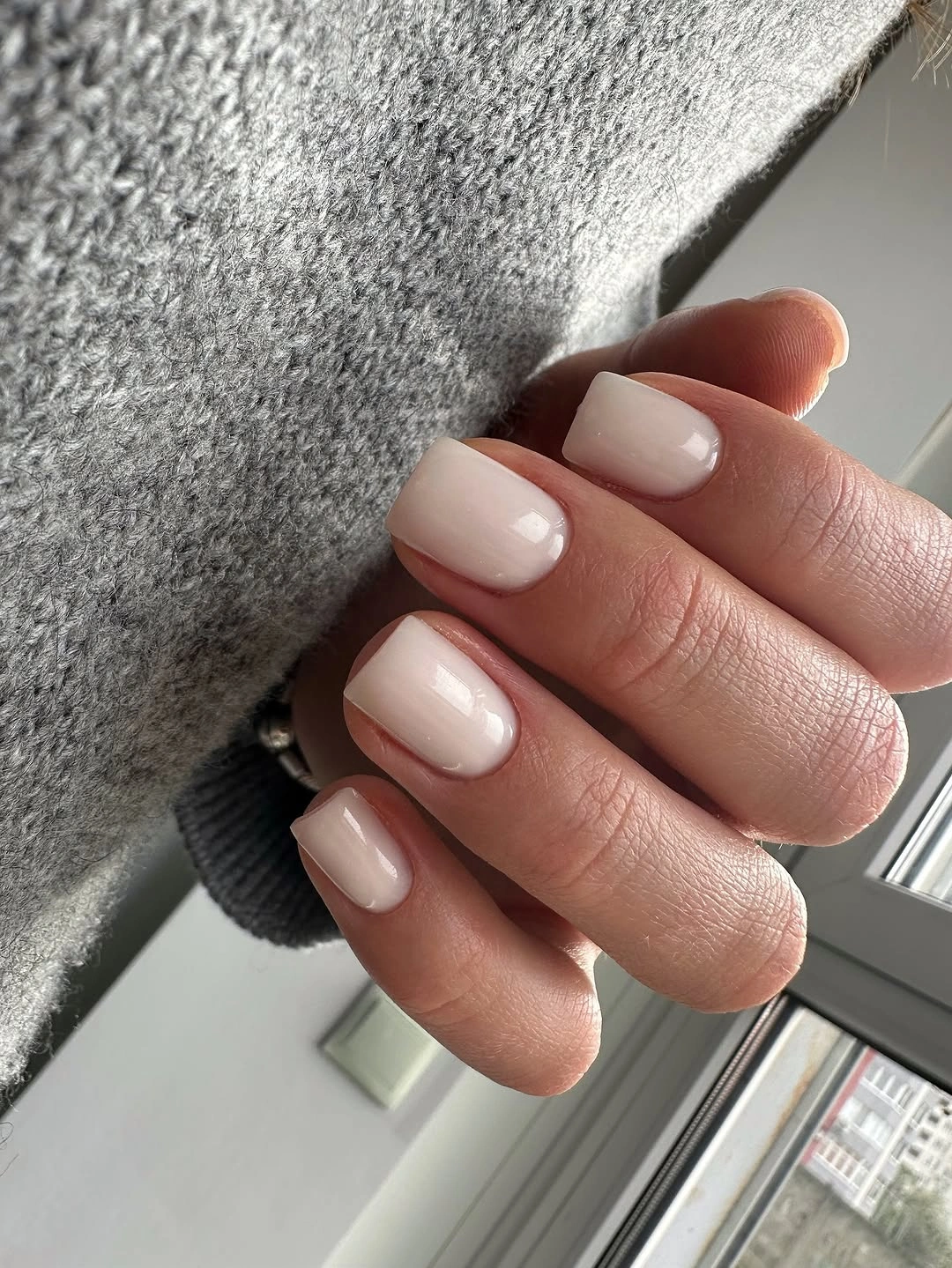 Short square nails in a creamy glossy pink-beige nude shade