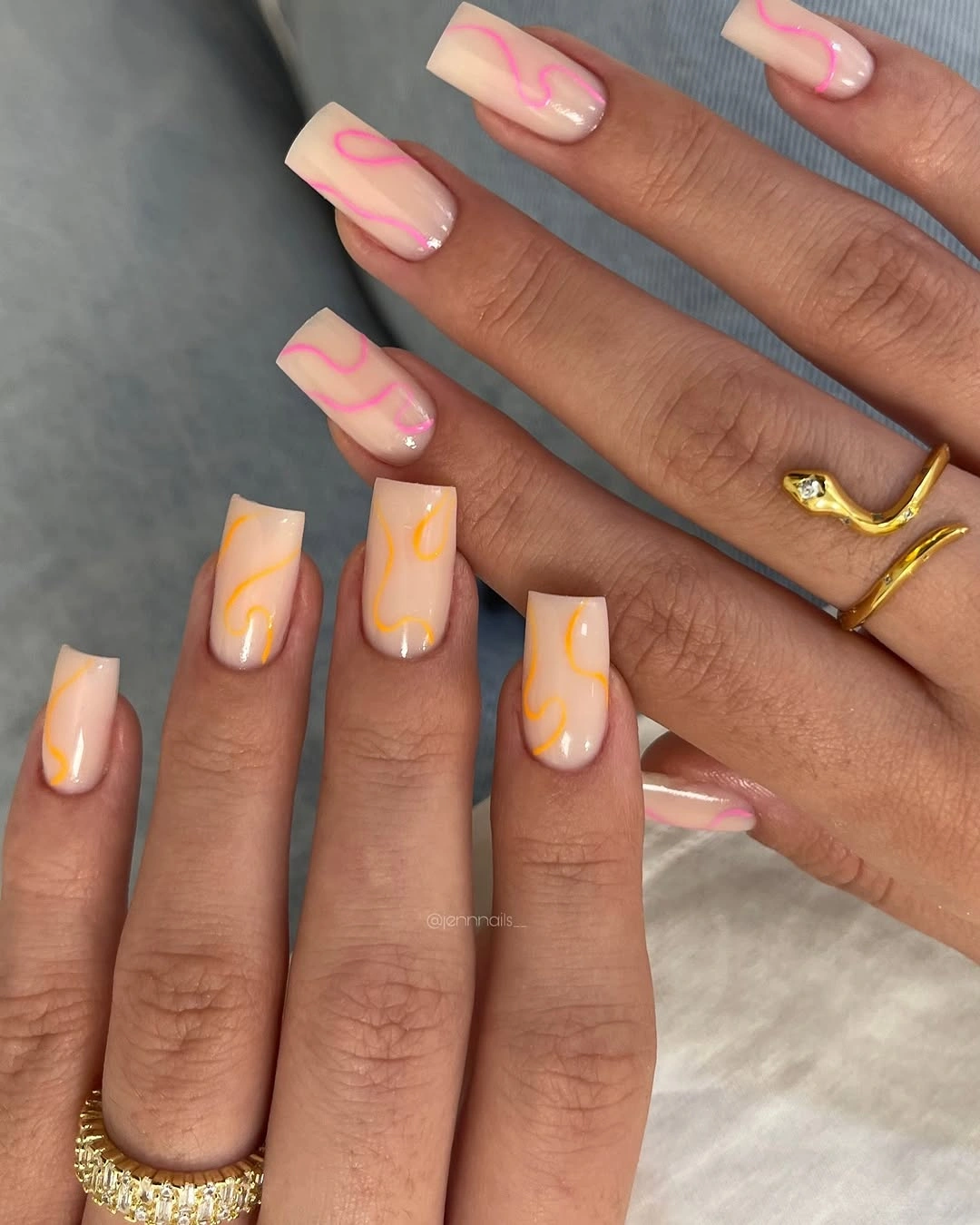 Long pale yellow square nails with loose soft pink swirling accents