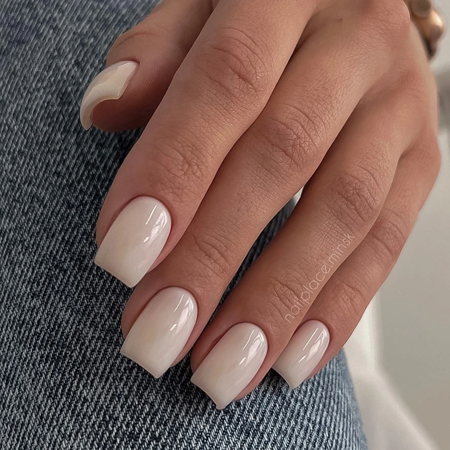 Short squoval nails in a light glossy blush-pink neutral shade