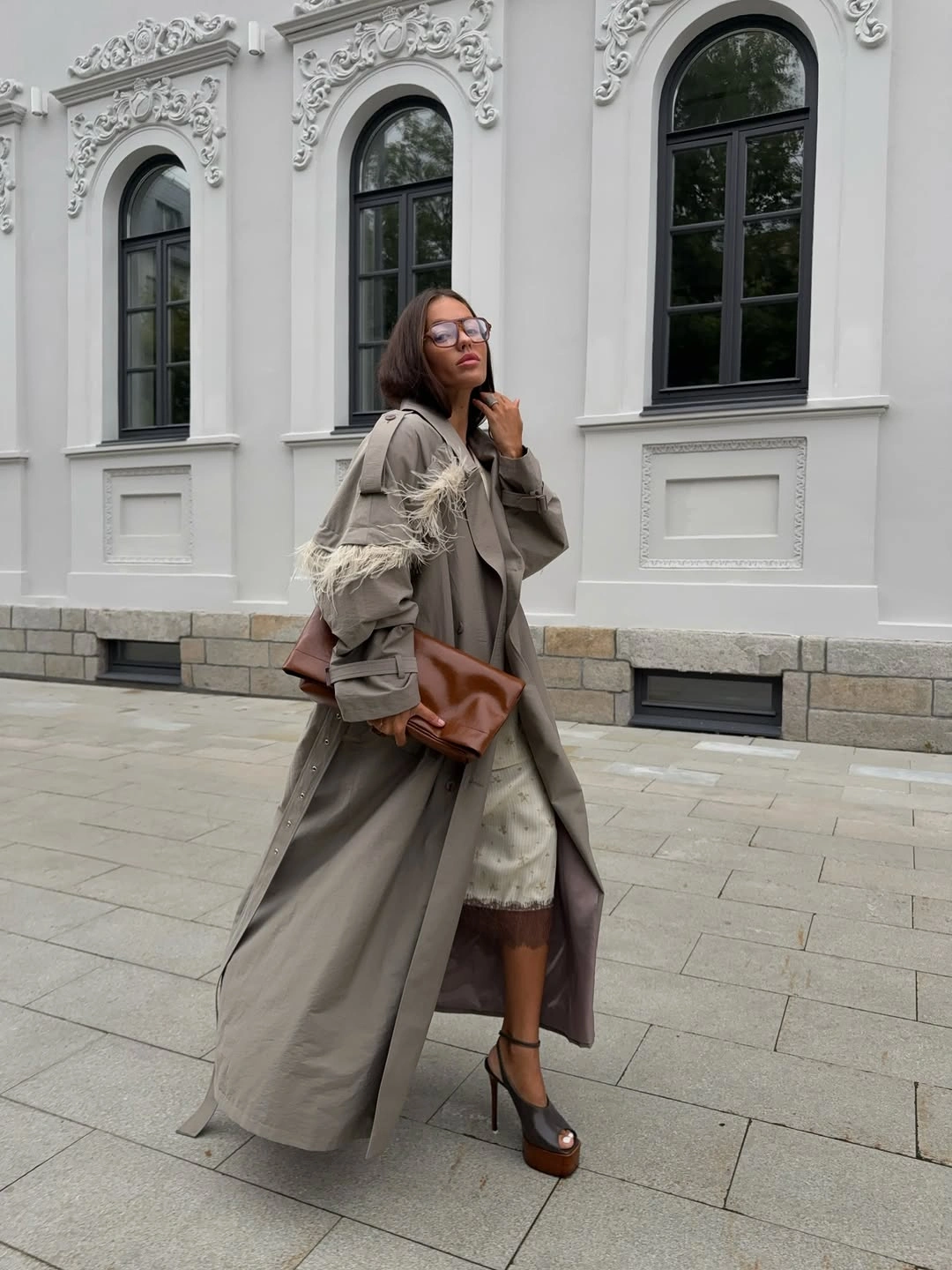 Taupe flowing coat with pale layers brown bag and heeled shoe