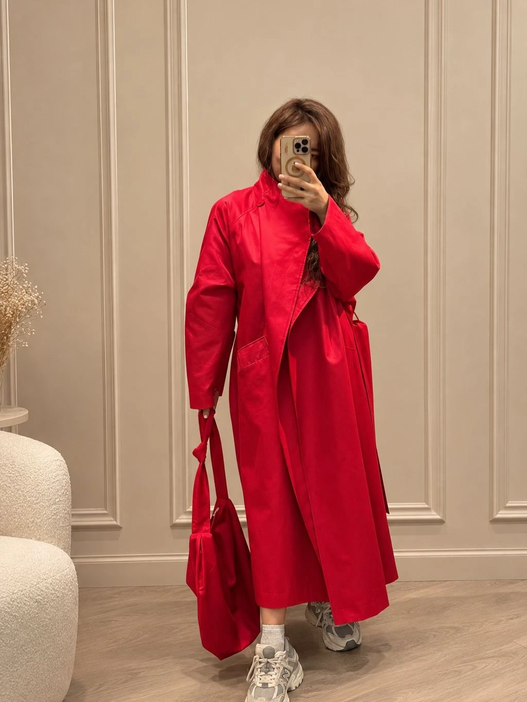 Bright red long coat with red bag and white trainers