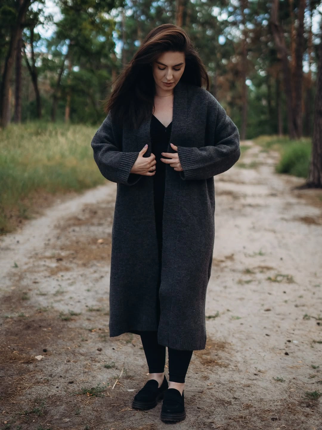 Long charcoal cardigan over black top leggings and chunky shoes