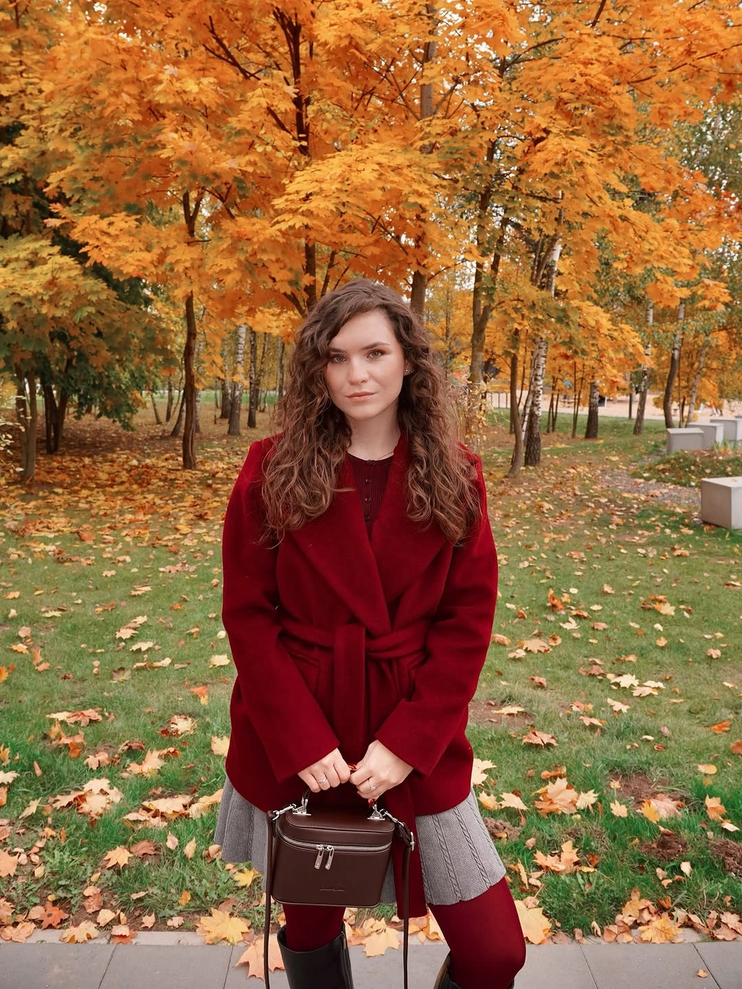 Burgundy knit top with gray trousers brown boots and bag