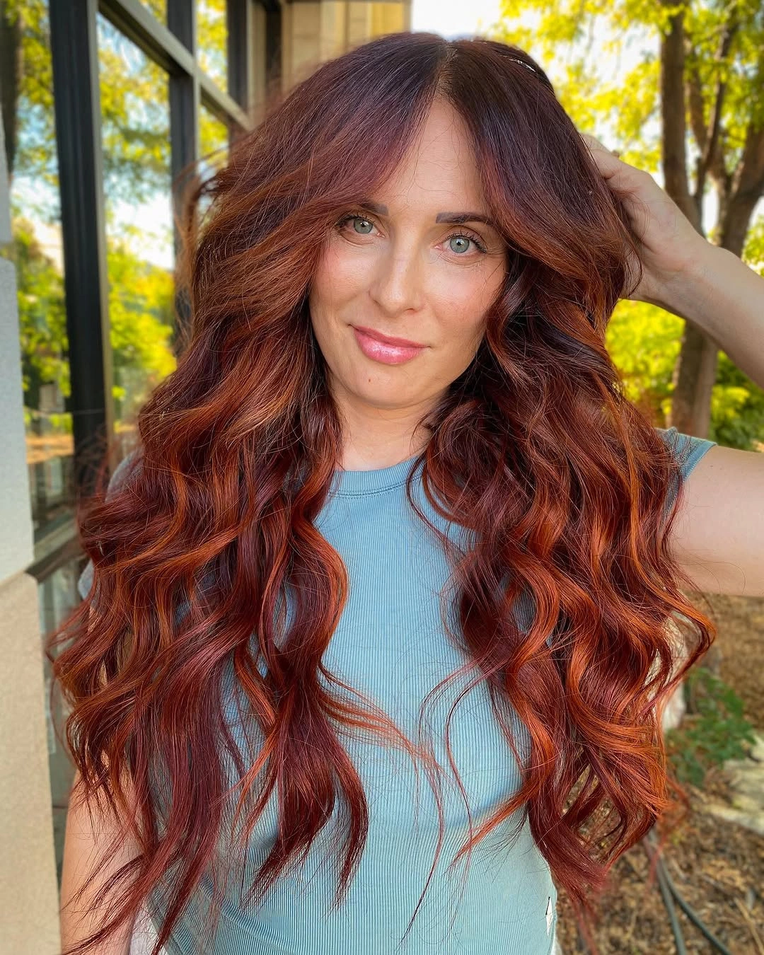 Long burgundy wavy hair with bright copper ribbons
