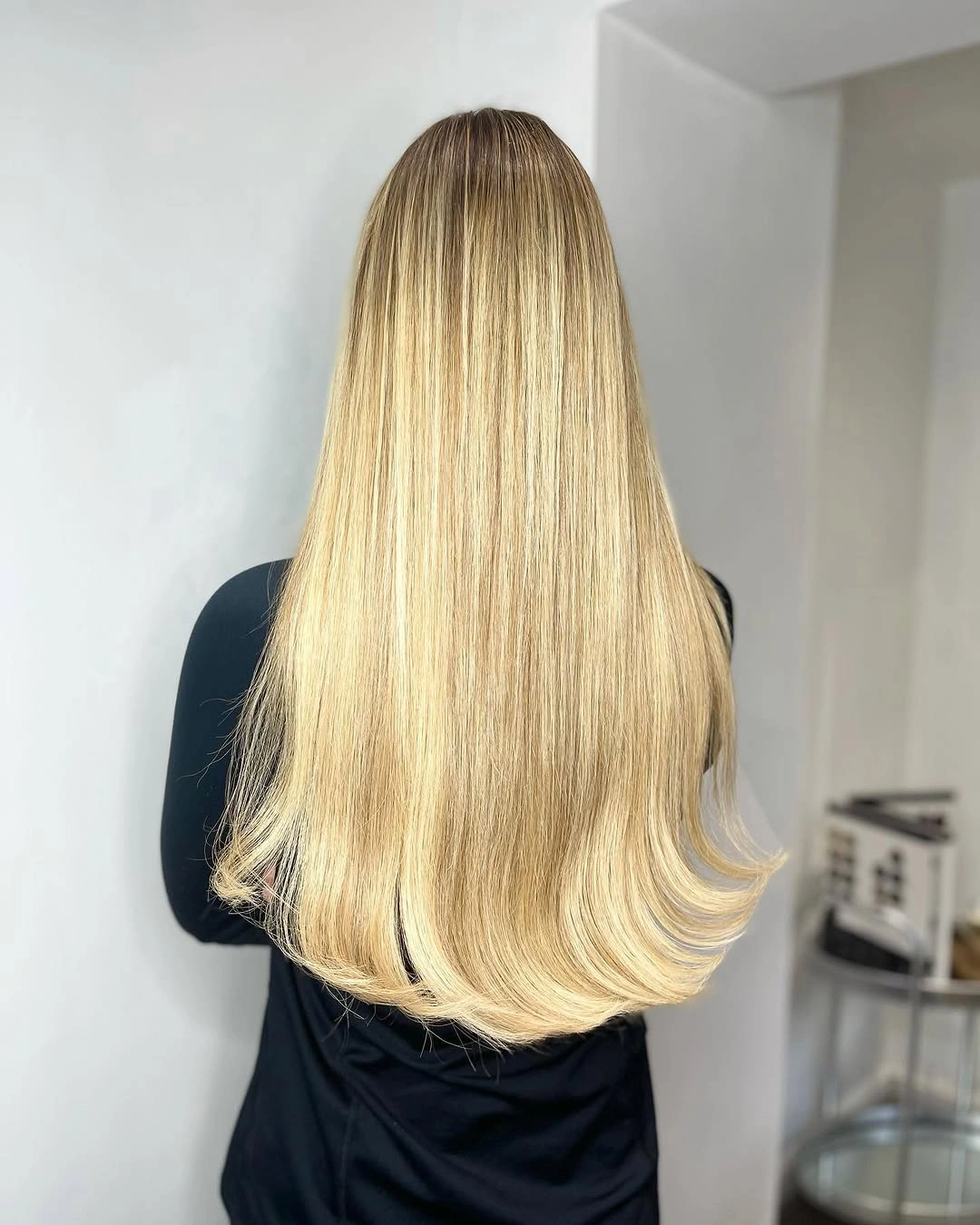 Very long soft blonde hair with darker root depth