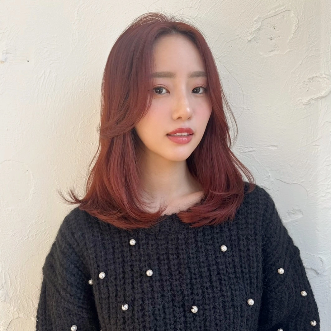 Shoulder length muted red brown hair with turned ends
