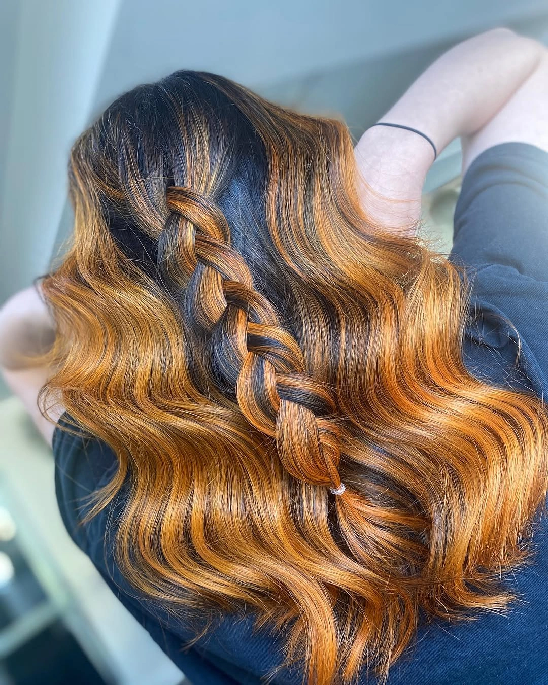 Dark wavy hair with caramel ribbons and loose crown braid