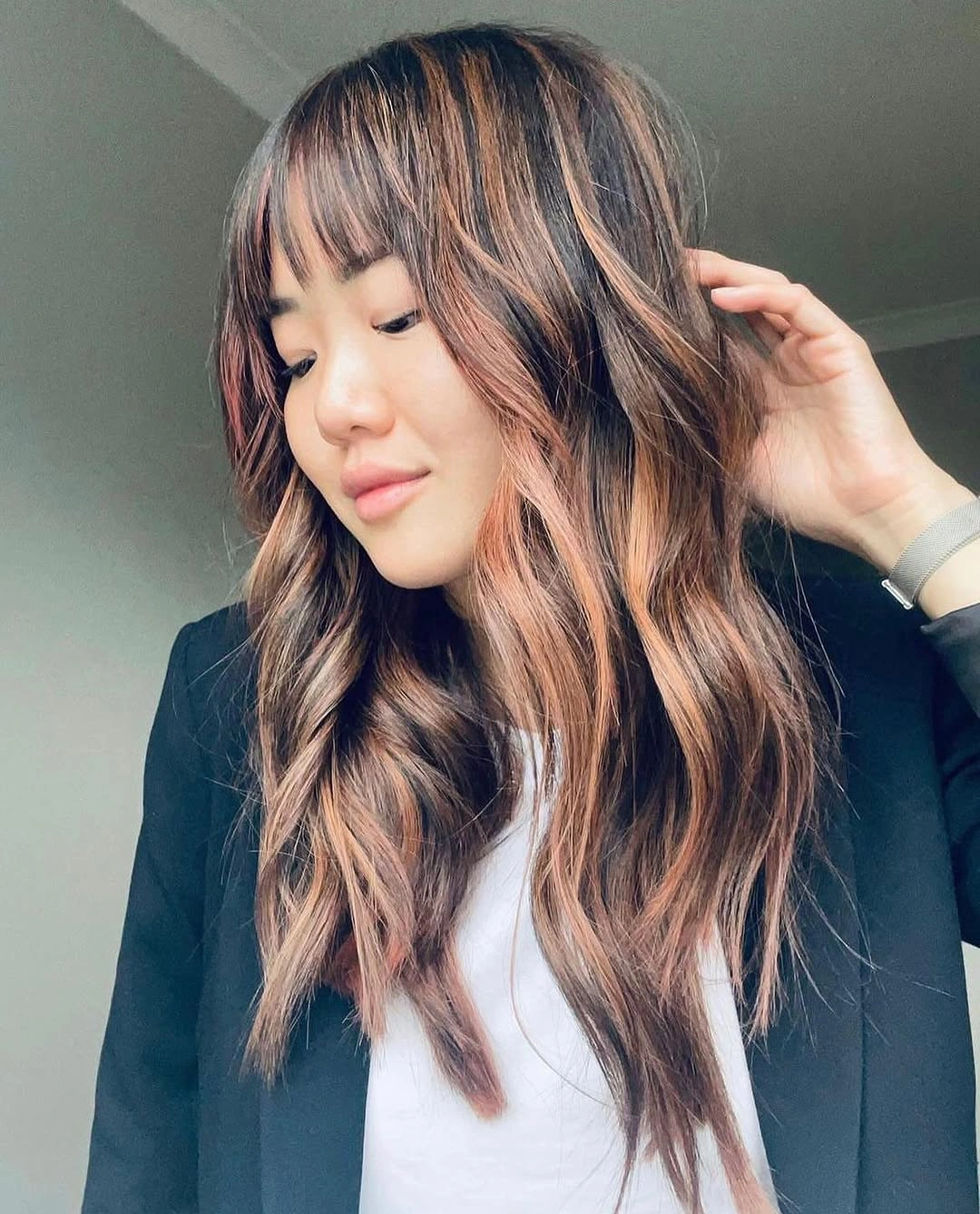 Dark brunette shag with caramel ribbons and wispy bangs
