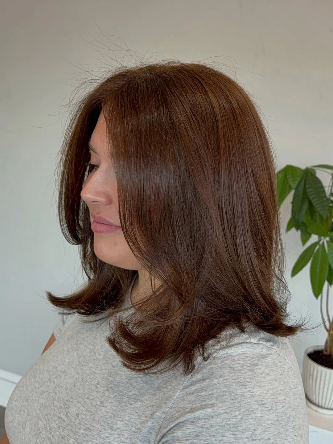 Medium long brown hair with swooping face framing layers
