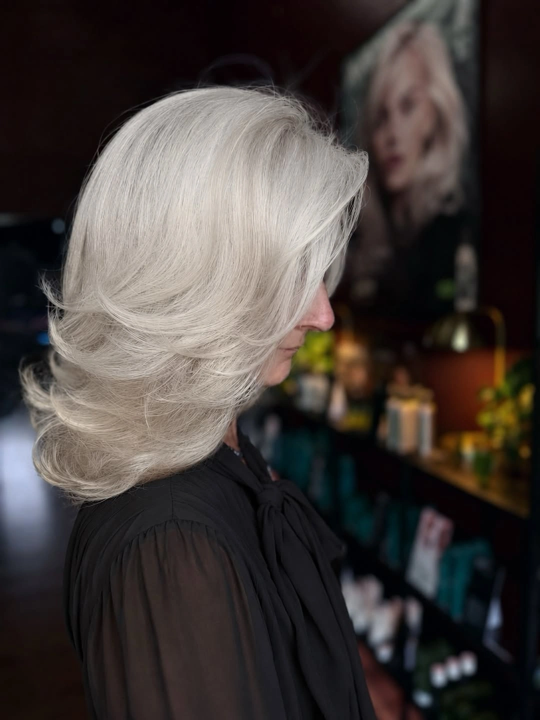 Silver shoulder length layers with sweeping side fringe