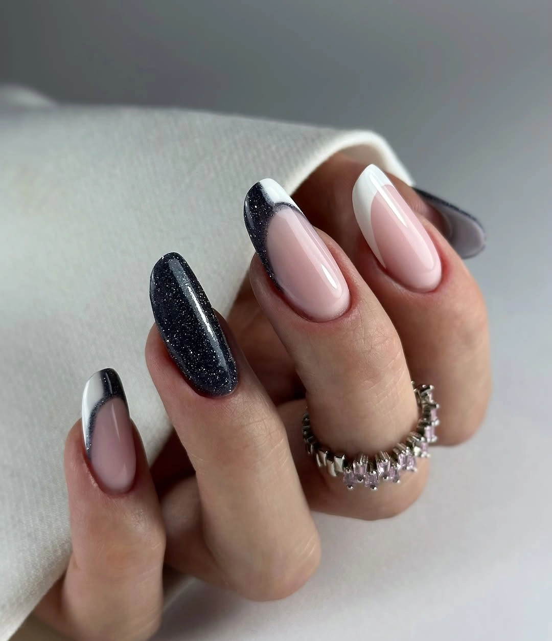 Rosy nude almond nails with black French edges and glitter