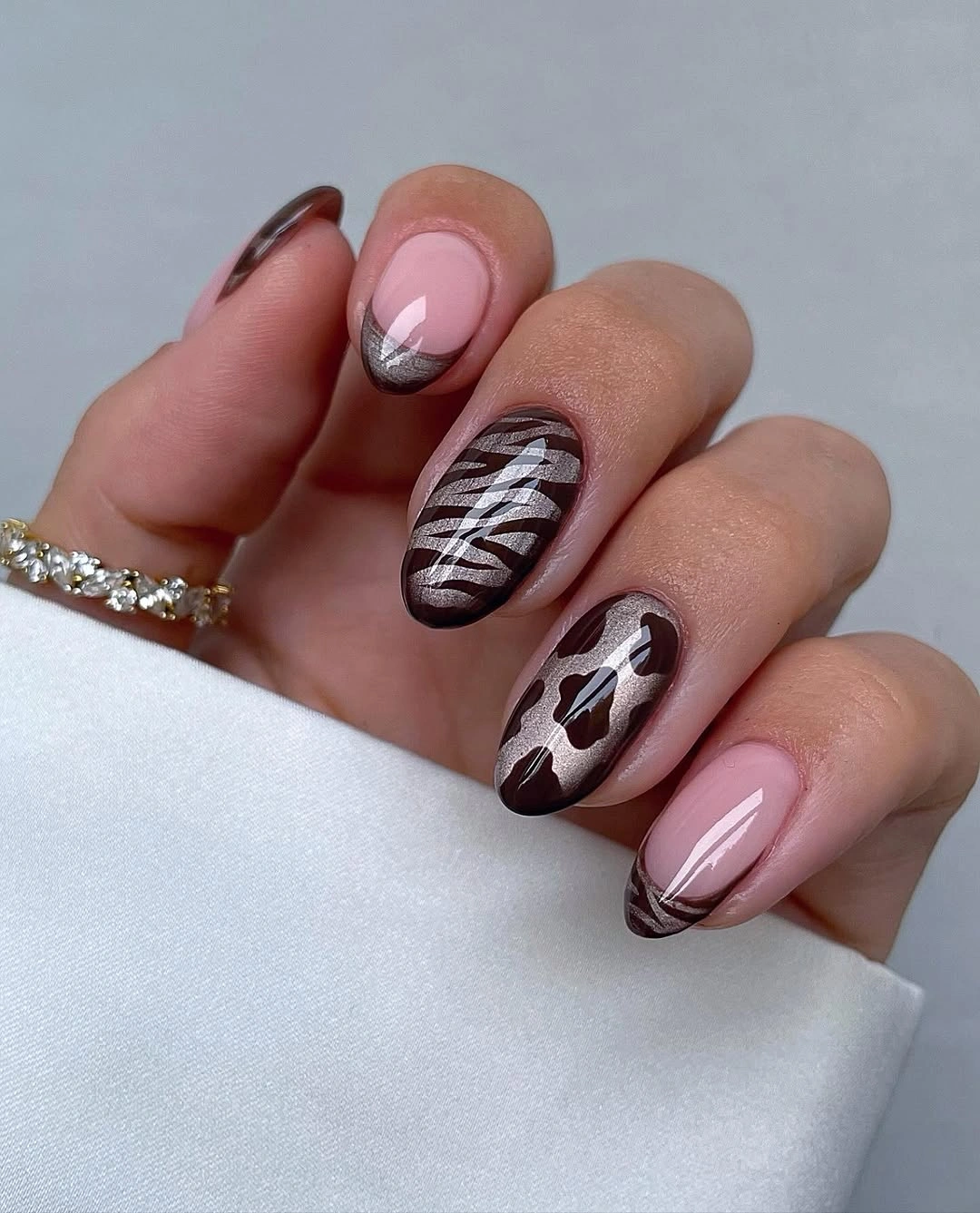 Mauve nude almond nails with brown animal print accents