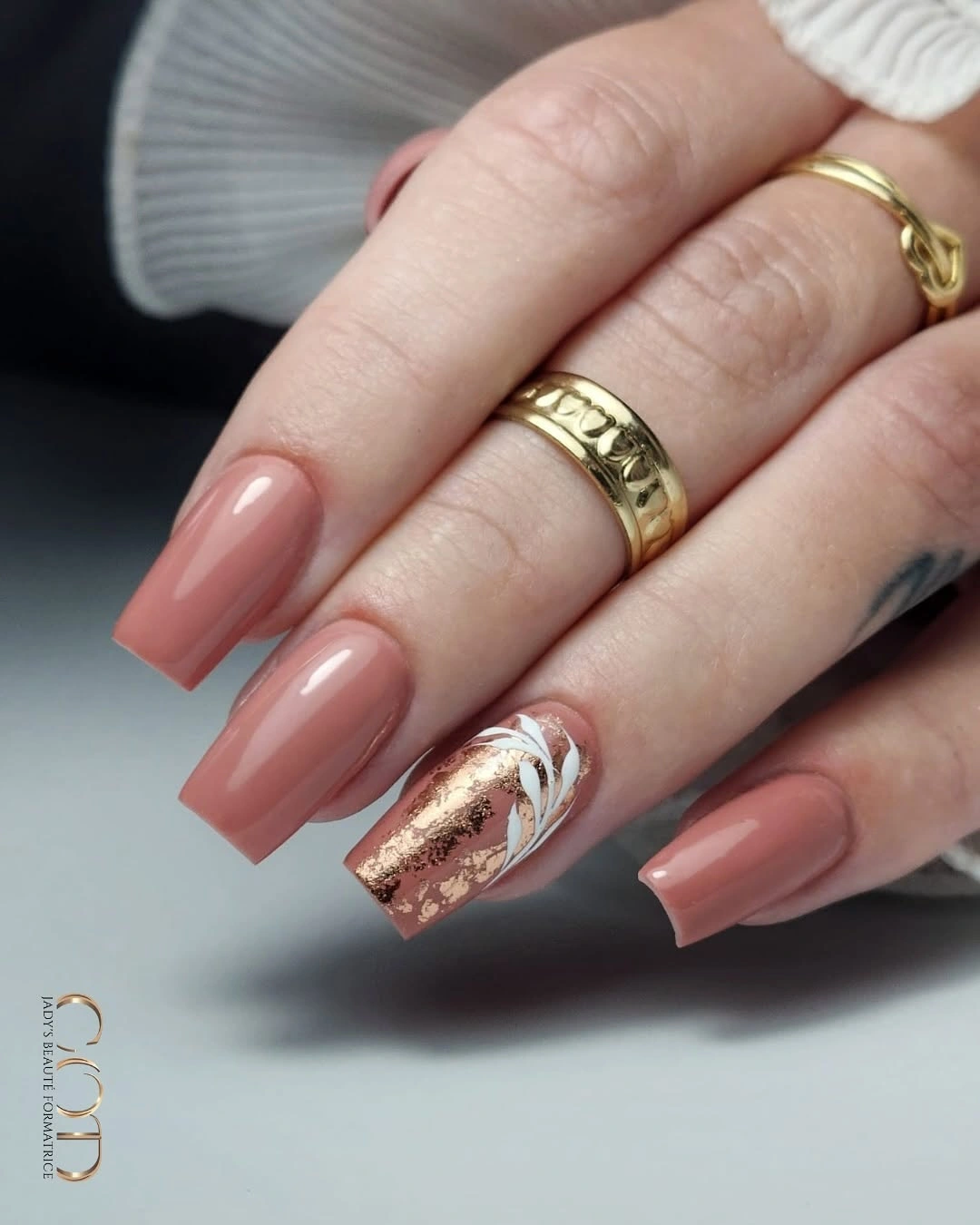 Long peach square nails with one gold fleck accent