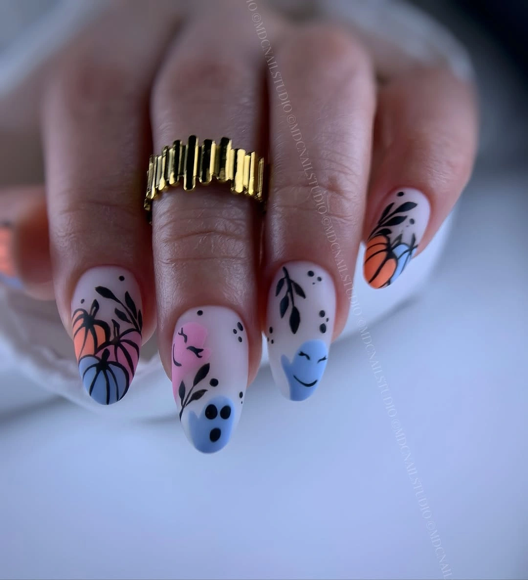 Long pale almond nails with lavender floral black linework
